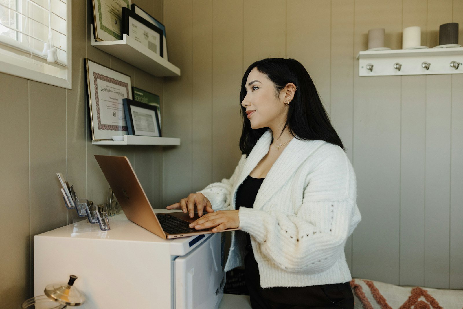 The Best AI Tools for Small Business in 2026 (The Ones That Actually Earn Their Keep) Small business owner working at a desk on a laptop