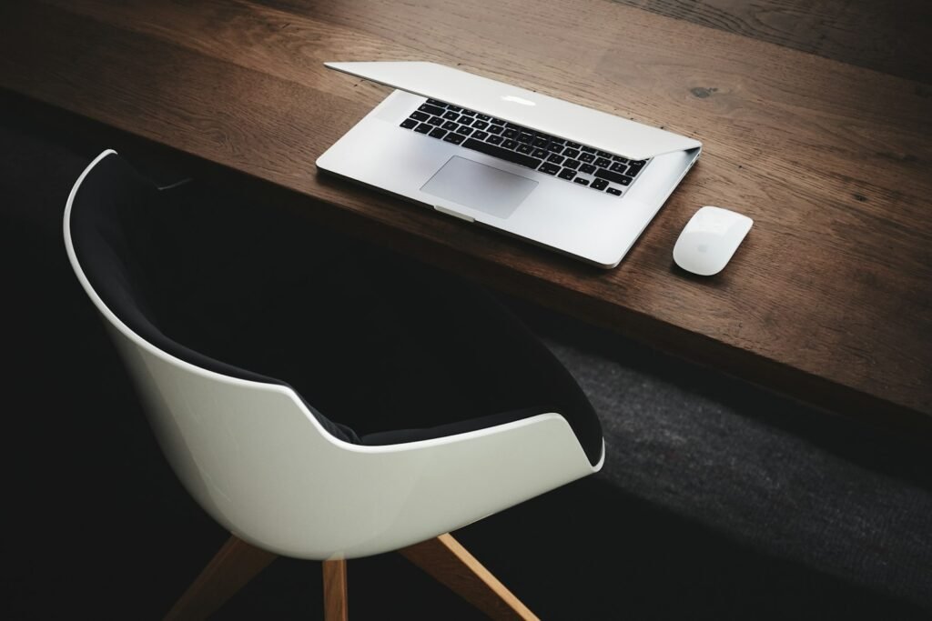 Laptop and notebook on a desk, representing research tools