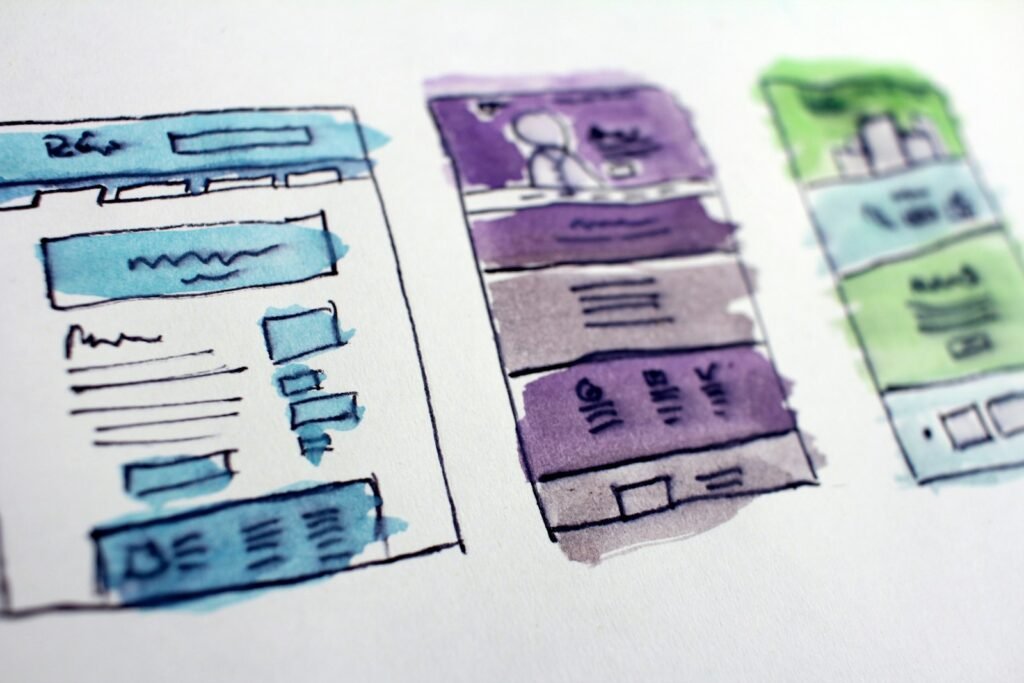 Watercolour wireframe sketches of website layouts
