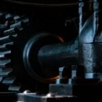 Close-up photograph of black metal gears meshing together