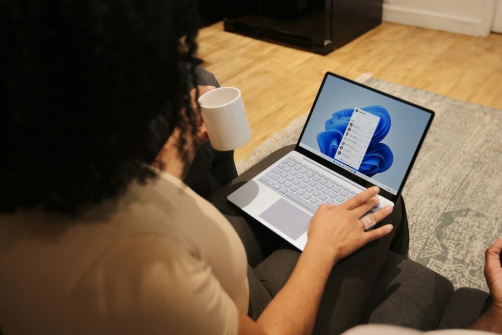 Person working on a Microsoft laptop at a desk
