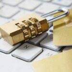 Golden padlock resting on a keyboard, representing defensive security tooling