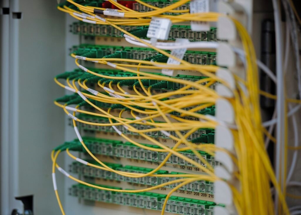 Neatly connected yellow and green network cables in a data centre