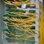 Neatly connected yellow and green network cables in a data centre